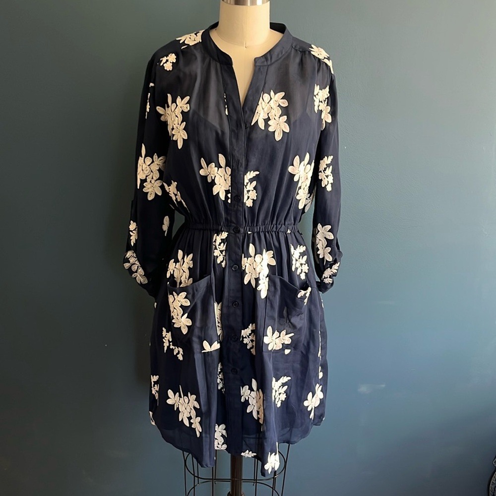 Navy blue dress with floral embroidery.